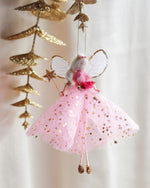 Load image into Gallery viewer, Decorative fairy with pink dress and gold accents hanging against a light background
