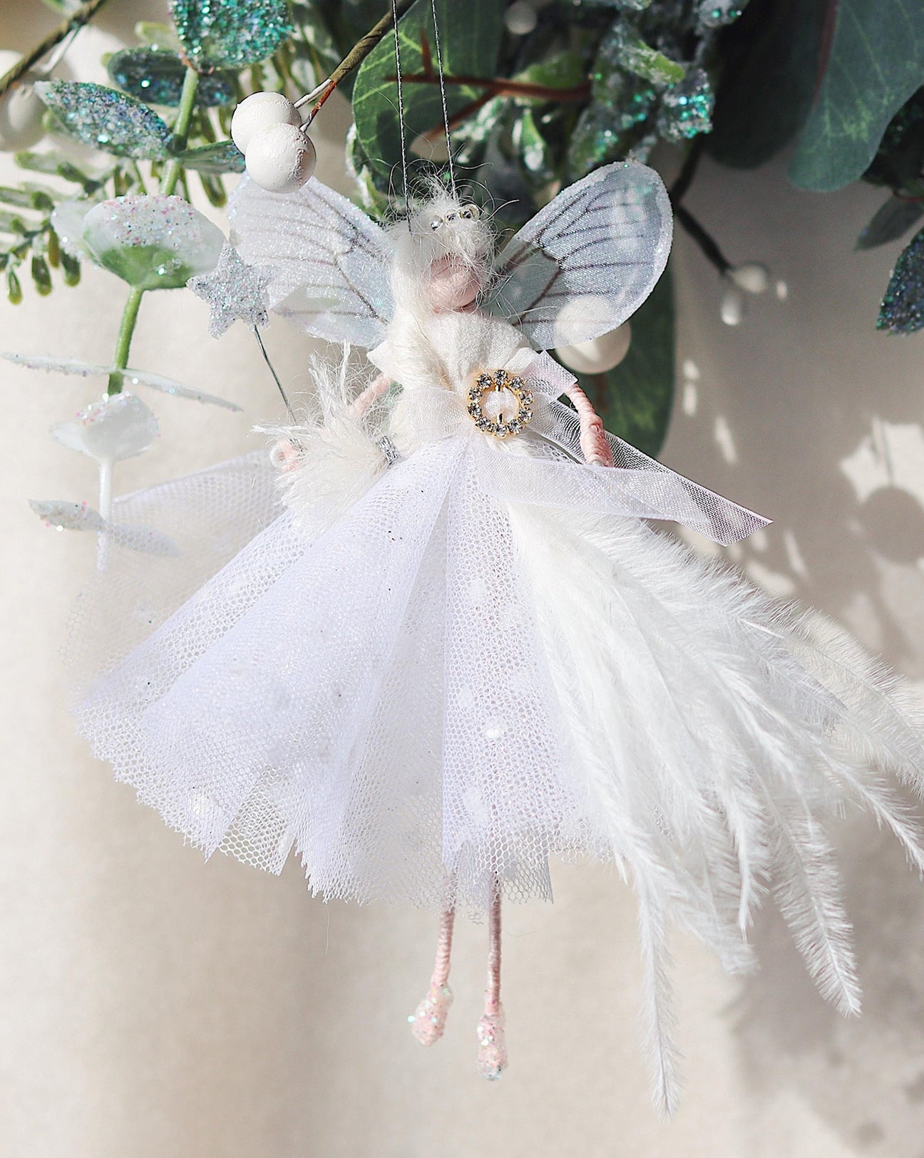 Close-up of Snowflake Fairy's delicate white spotty overskirt and glittery wings, adding a touch of winter elegance to holiday decor