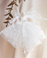 Load image into Gallery viewer, White tulle skirt with polka dots and decorative elements on a neutral background
