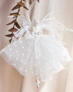 White tulle skirt with polka dots and decorative elements on a neutral background