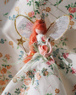 Load image into Gallery viewer, Small fairy figurine with red hair and floral dress on a floral background
