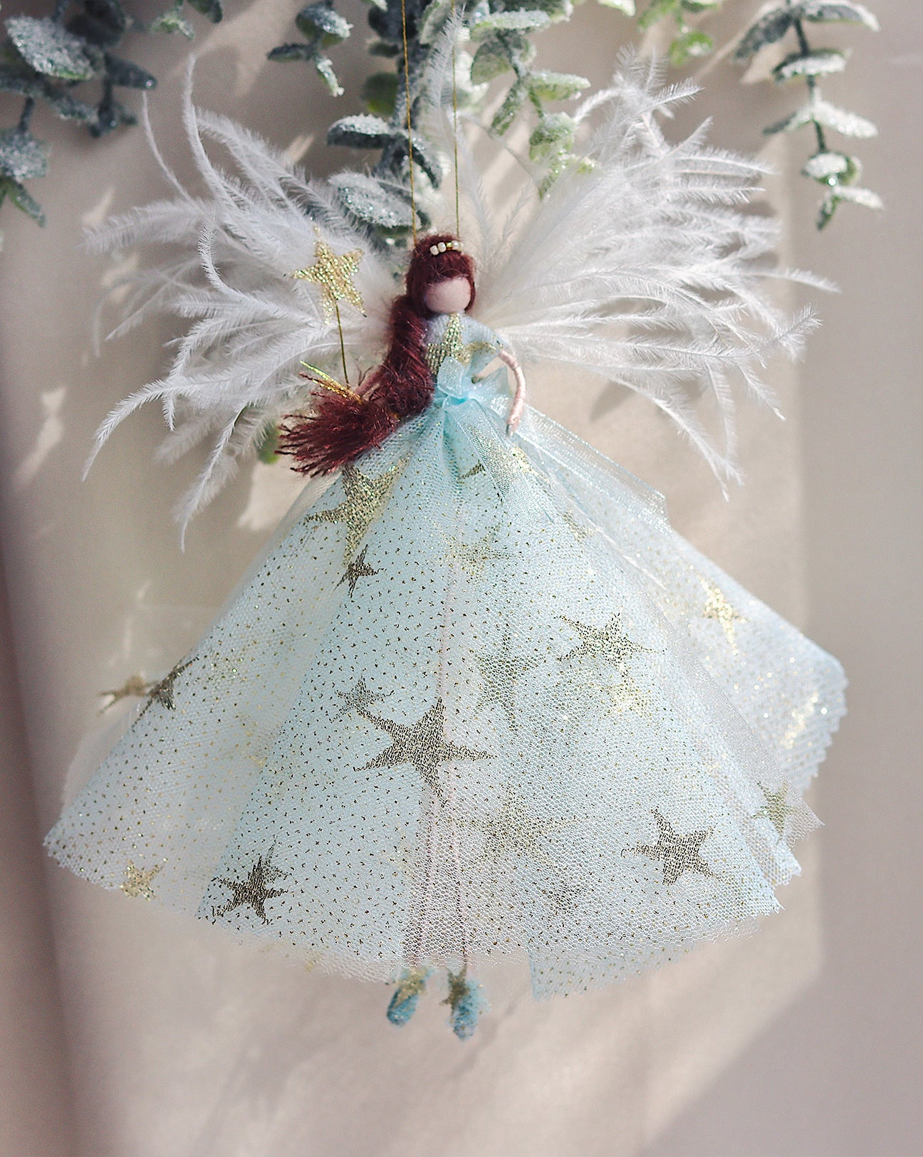 brown haired fairy wearing a iced blue dress with gold stars and gold shimmering glitter. magic wand a large feathered wings. the perfect christmas gift. handmade fairy angel decoration to hang on the christmas tree