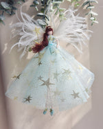 Load image into Gallery viewer, brown haired fairy wearing a iced blue dress with gold stars and gold shimmering glitter. magic wand a large feathered wings. the perfect christmas gift. handmade fairy angel decoration to hang on the christmas tree
