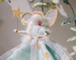 Christmas fairy decoration in teal pink and gold glitter sparkle. magical star wand