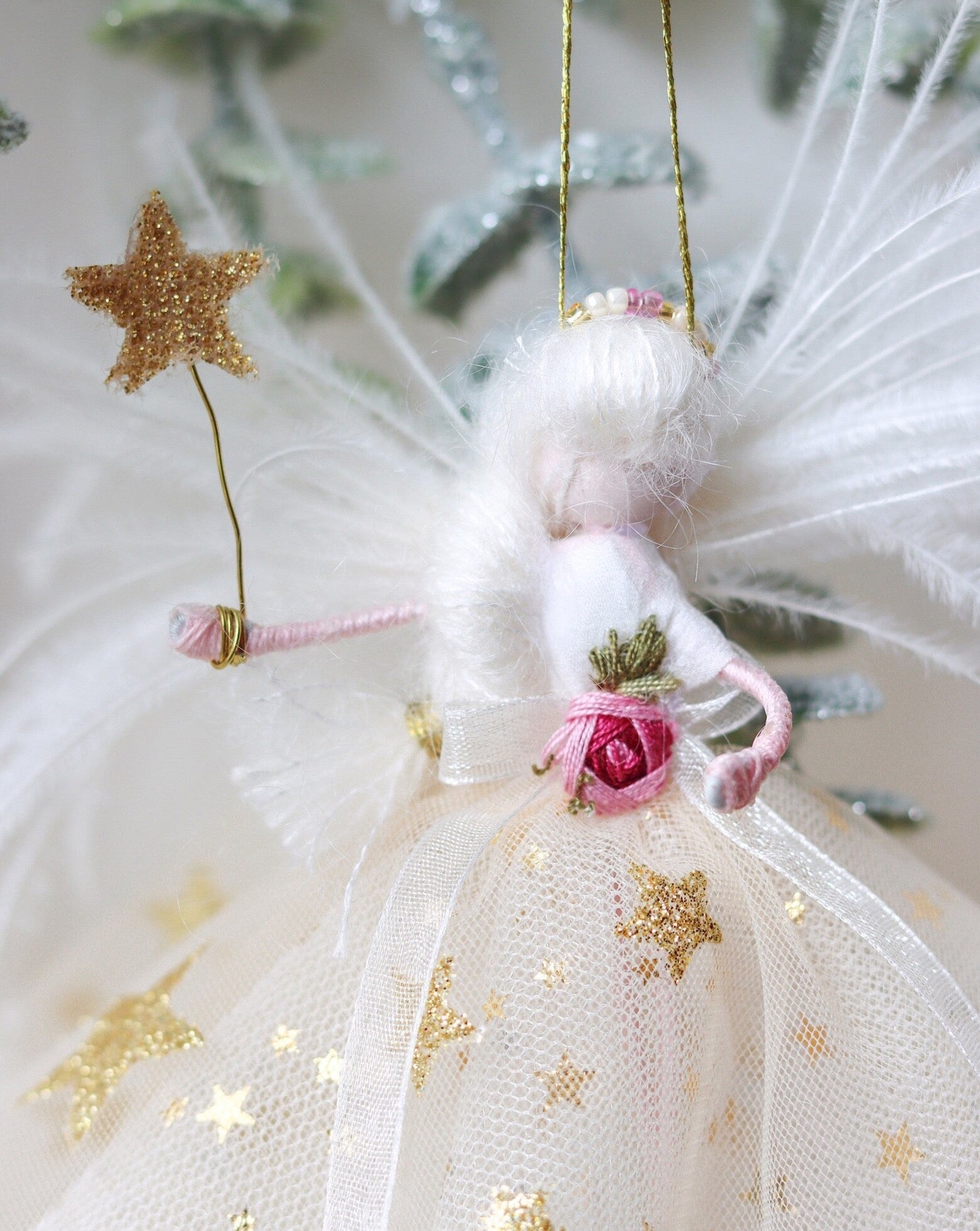 close up of fairy decoration in gold star sparkly tulle fabric ready to sit on top of the christmas tree