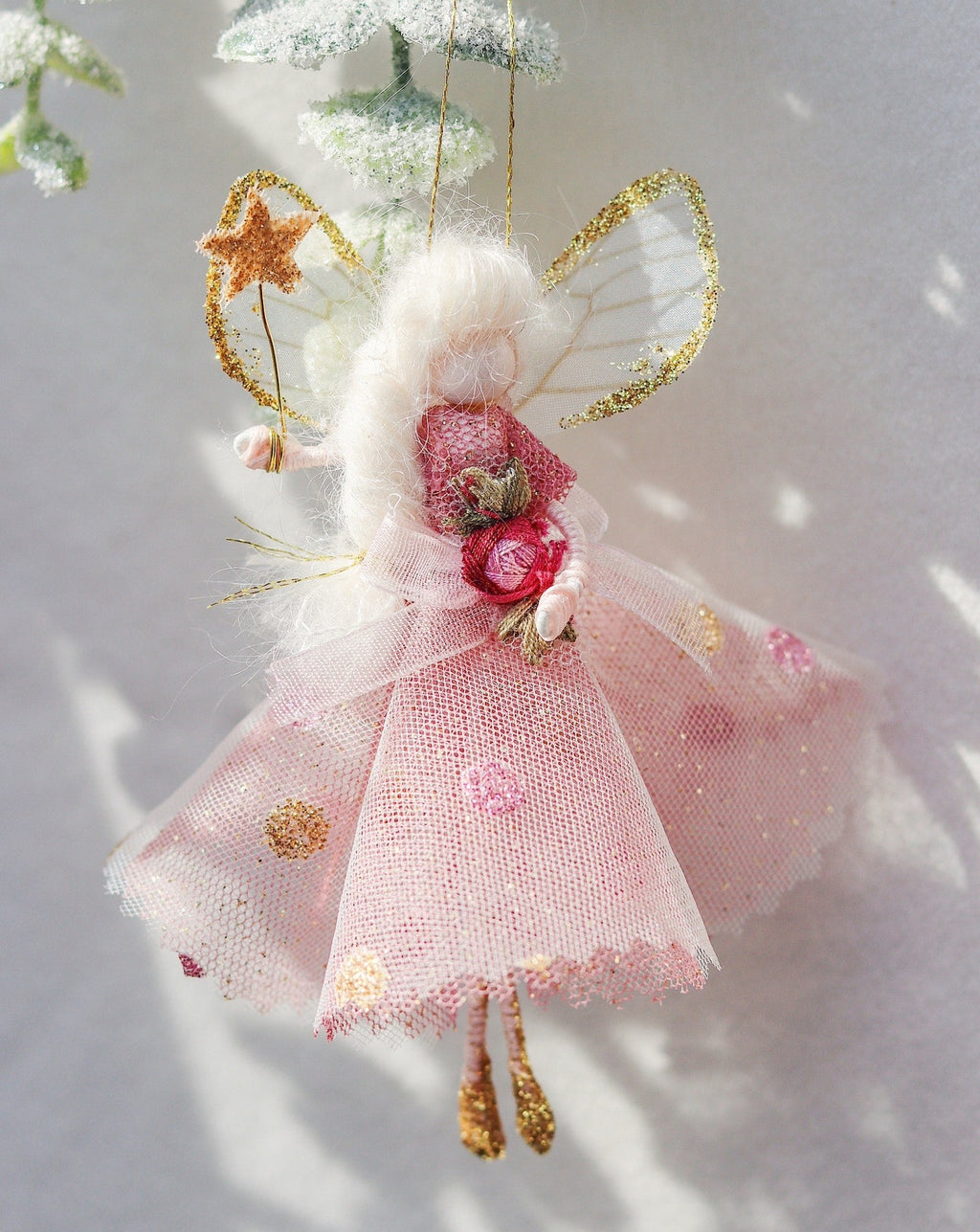 This little fairy is dressed in a pink glitter tulle with a spotted tulle overlay. She has sashed her gown at the waist with an Organza ribbon and a little pink embroidered rose trim. She has little shoes dipped in glitter and of course, her glittered wand to grant you your wishes!