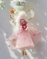 Load image into Gallery viewer, This little fairy is dressed in a pink glitter tulle with a spotted tulle overlay. She has sashed her gown at the waist with an Organza ribbon and a little pink embroidered rose trim. She has little shoes dipped in glitter and of course, her glittered wand to grant you your wishes!
