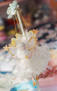 This little fairy is dressed in a white spotted tulle with a gold star tulle underskirt. She has sashed her gown at the waist with an Organza ribbon and a little gold star trim. Her little shoes dipped in glitter and of course, her glittered wand to grant you your wishes!