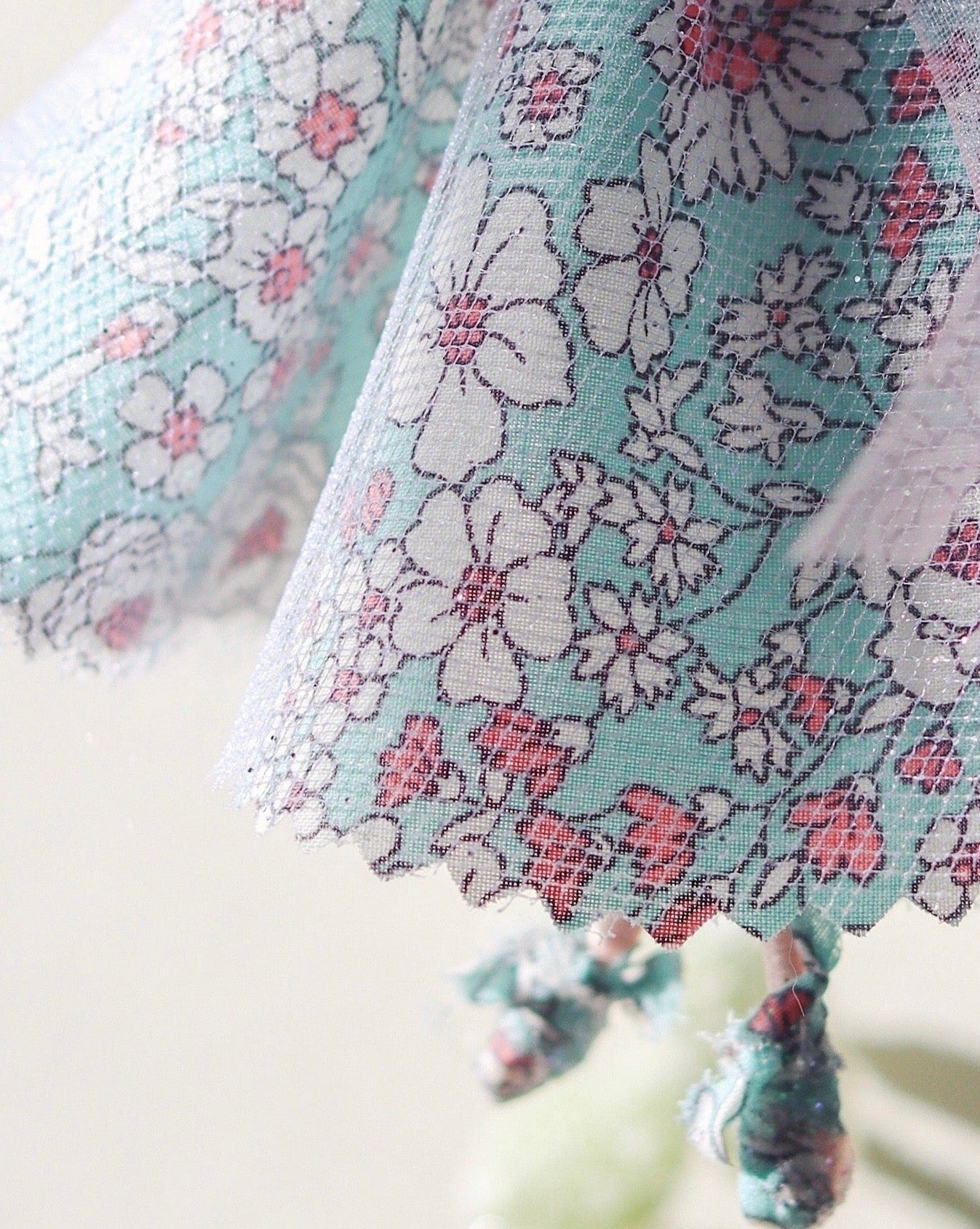 upclose of liberty flower fairy dress decoration. handmade gift. pink and blue floral