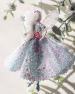 Load image into Gallery viewer, This Fairy is a unique, one-of-a-kind product, handmade by a bridal designer from all her cherished fabrics. It is an item to treasure, a special family heirloom. As each fairy is handmade and unique. This fairy wears a Liberty Print floral dress in blue and pink. The perfect addition to a nursery or gift for a loved one.
