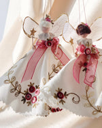Load image into Gallery viewer, Decorative fairy figurines with pink ribbons and floral details on a soft background. inspired by the gowns of Bridgerton. Handmade heirloom gift.
