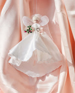 Load image into Gallery viewer, Decorative bride fairy  figurine with a white dress on a soft pink background holding a miniature bouquet bridal gift, wedding present, new bride to be
