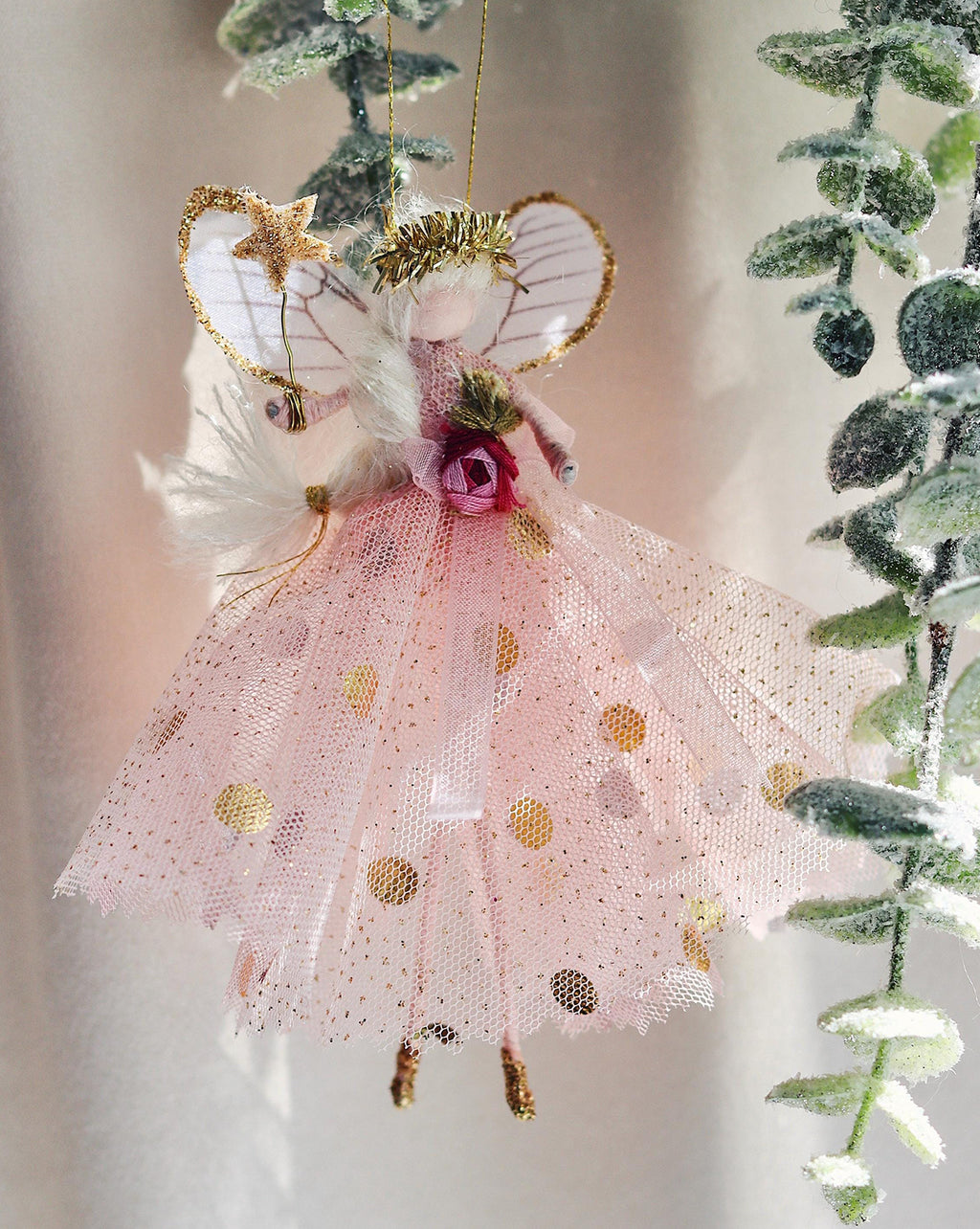 This fairy wears an enchanting antique glitter tulle gown with a playful gold polka-dot underskirt. Her waist is beautifully sashed with an organza ribbon and trim, while her glitter-dipped shoes and tinsel tiara add a touch of sparkle. Delicate silk organza wings complete her magical look, and of course, she holds her signature glittered wand—ready to grant your wishes!