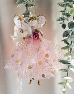 This fairy wears an enchanting antique glitter tulle gown with a playful gold polka-dot underskirt. Her waist is beautifully sashed with an organza ribbon and trim, while her glitter-dipped shoes and tinsel tiara add a touch of sparkle. Delicate silk organza wings complete her magical look, and of course, she holds her signature glittered wand—ready to grant your wishes!