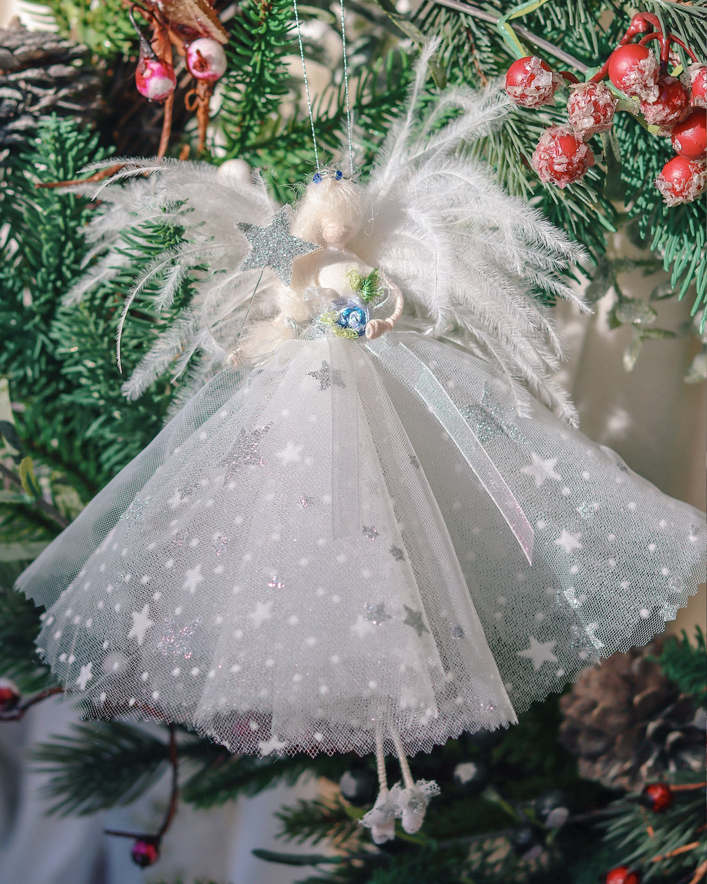 white and silver star fairy in the christmas tree