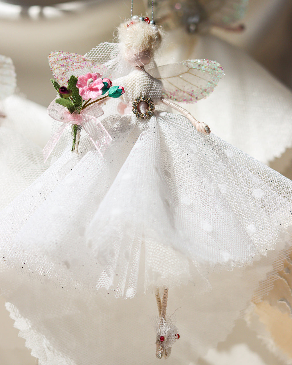 The Florialice Fairy Bride is a unique, one-of-a-kind product, handmade by a bridal designer from all her cherished fabrics. It is an item to treasure, a special family heirloom. As each fairy is handmade and unique.