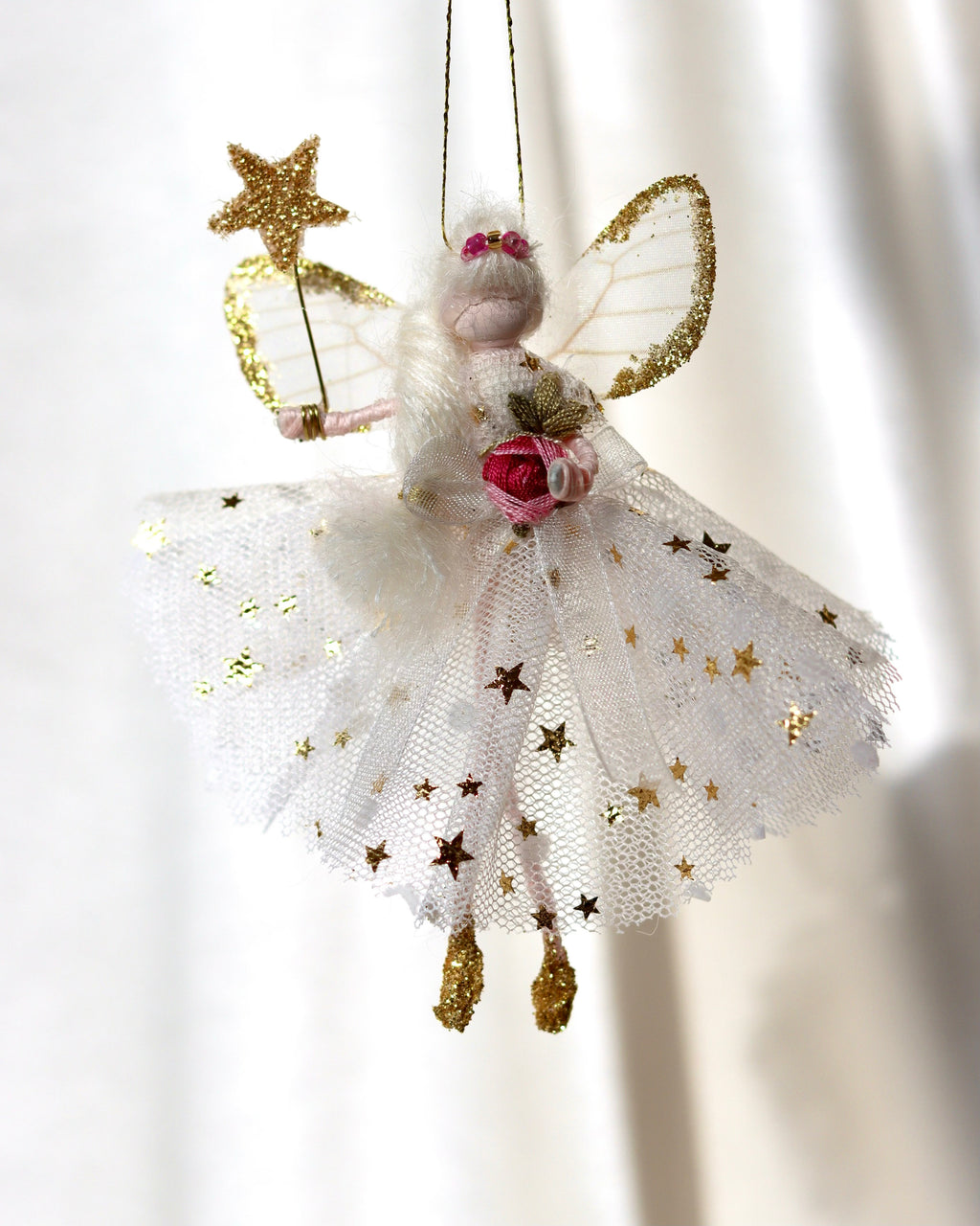 This little fairy is dressed in a Gold star and white polka dot gown. She has sashed her gown at the waist with an Organza ribbon and a little pink embroidered rose trim. She has little shoes dipped in glitter and of course, her glittered wand brings you never-ending memories!