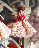 Load image into Gallery viewer, Made from the softest floral cotton and adorned with vintage fripperies. Valentine holds a magical golden wand and wears the sparkliest of wings. Vintage glass bead tiara sits upon her hair that catches the light and eyes of all onlookers 
