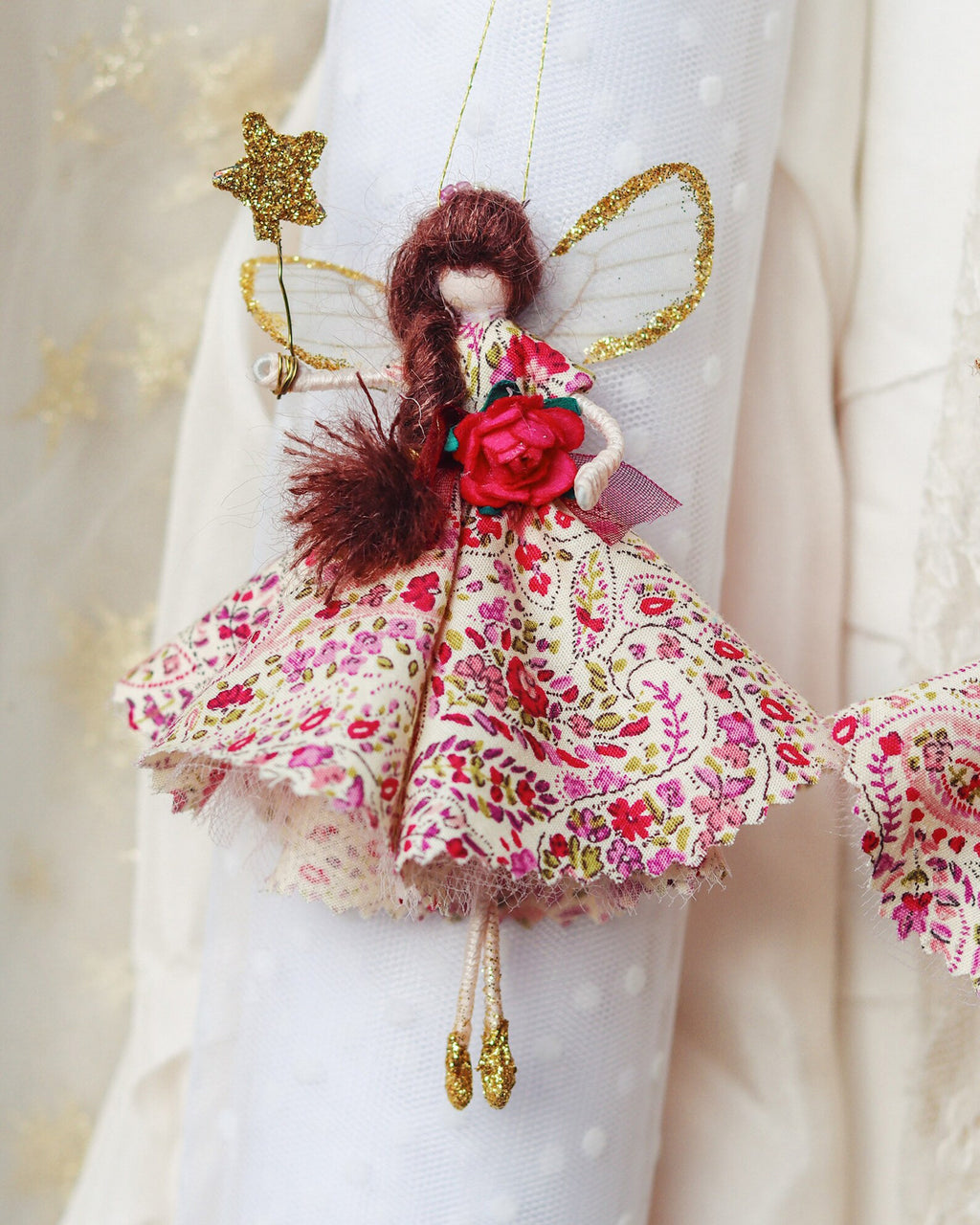 Made from the softest floral cotton and adorned with vintage fripperies. Valentine holds a magical golden wand and wears the sparkliest of wings. Vintage glass bead tiara sits upon her hair that catches the light and eyes of all onlookers 