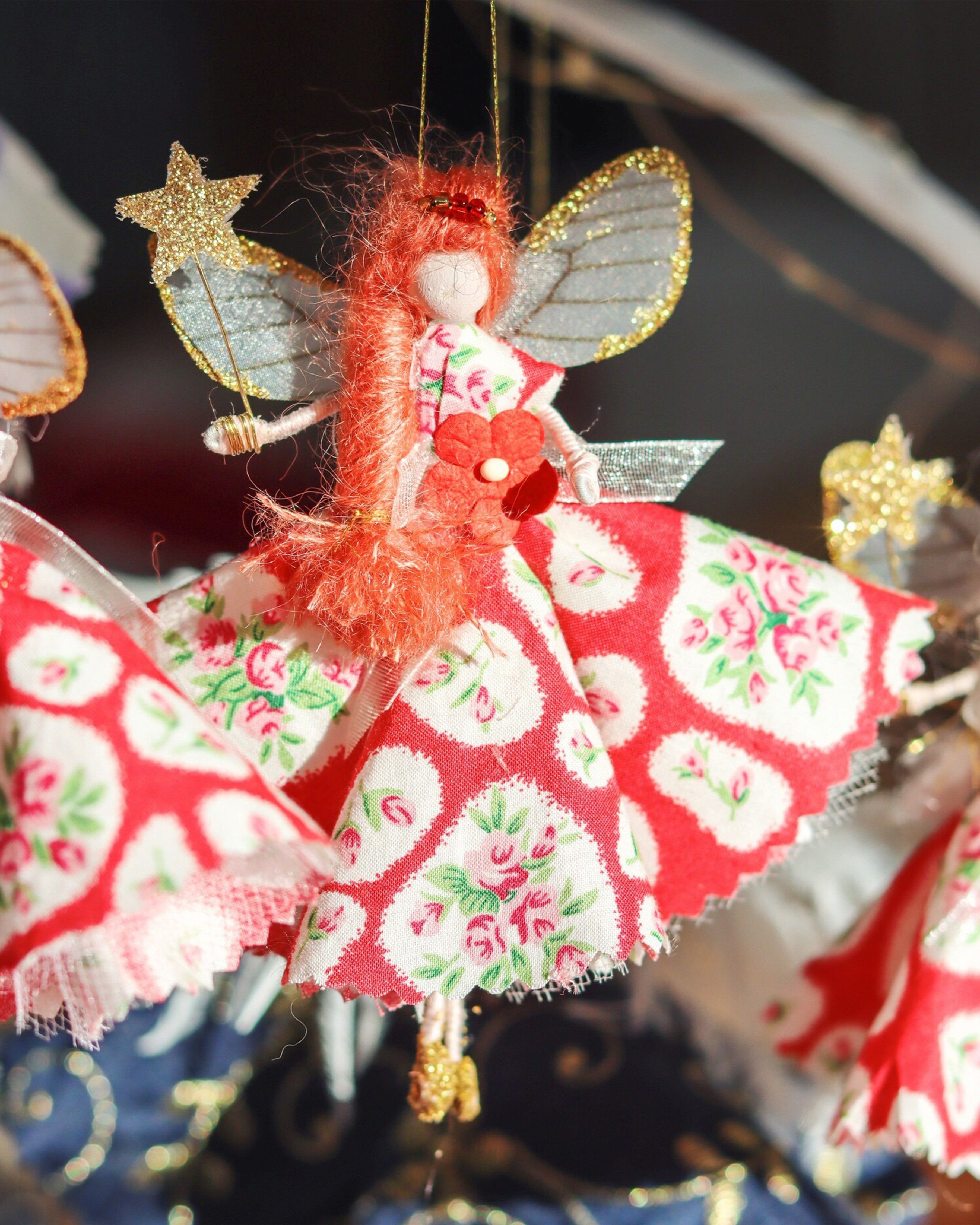 Red headed fairy wearing a floral pink dress